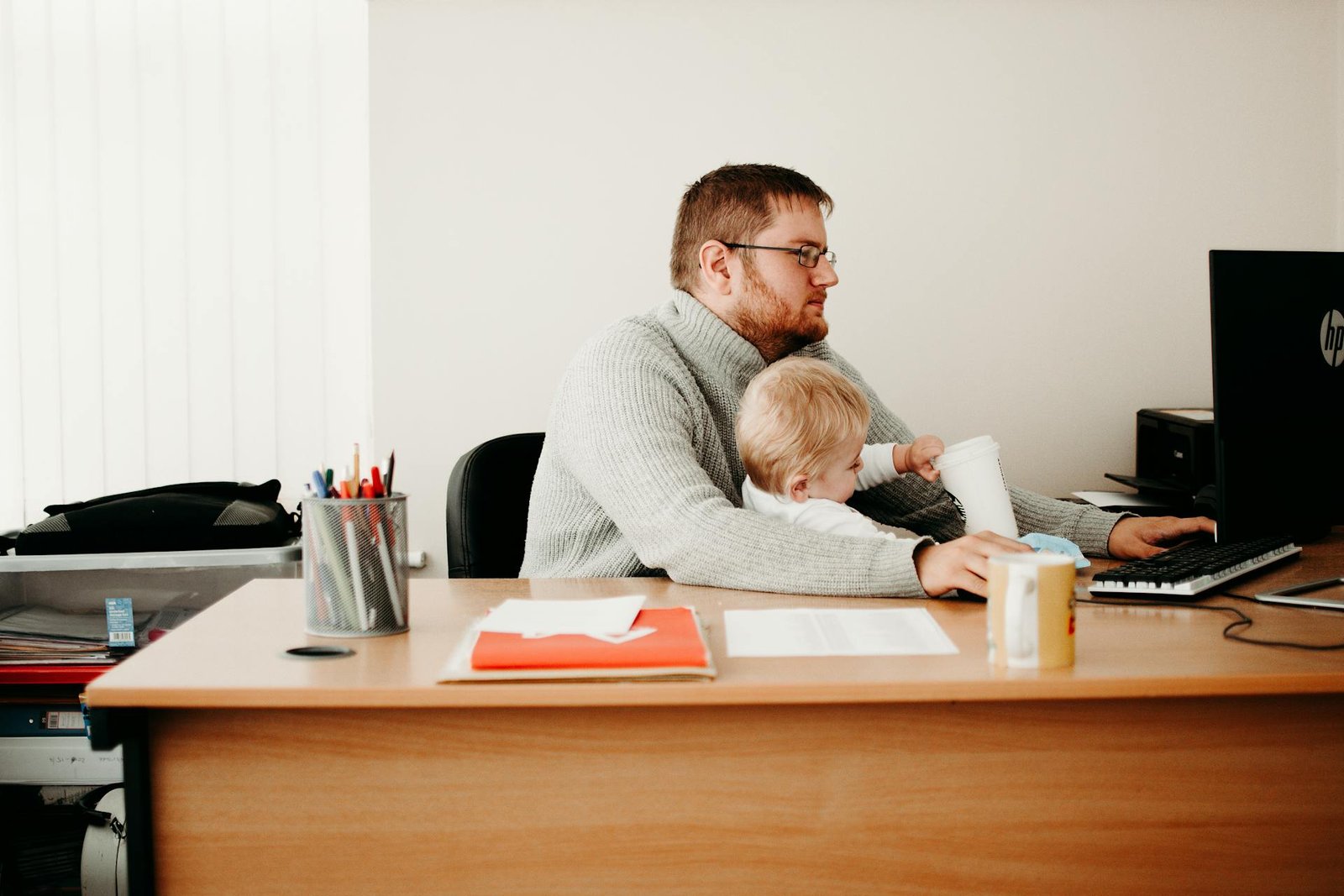 a man taking care of his son while working