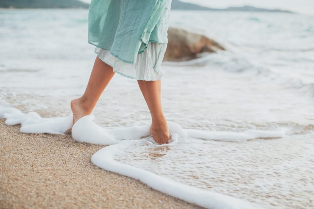 a woman walking on the sand