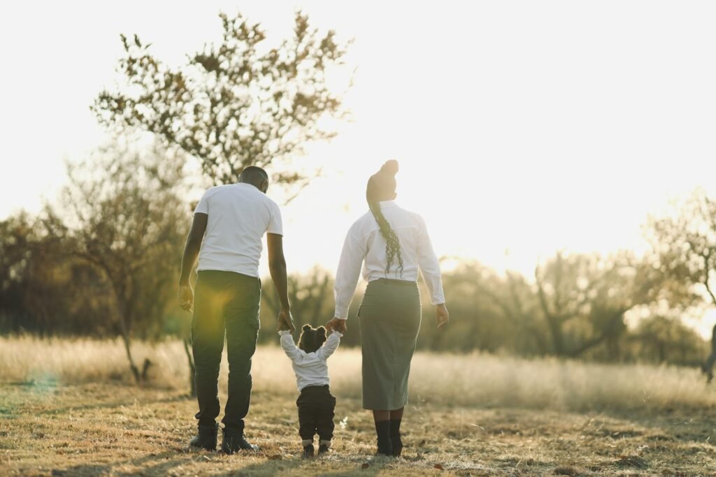 family walk in sunlit field