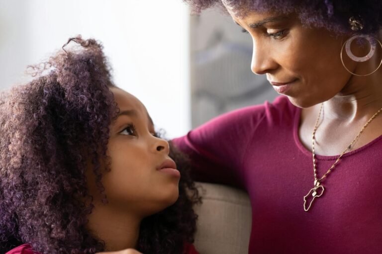 a mother and daughter staring at each other