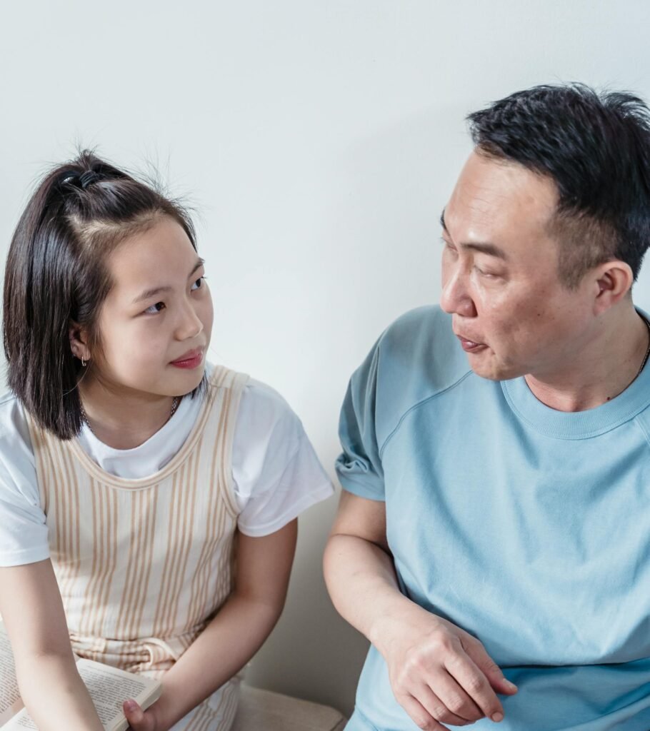 Listening in Parenting: A Quiet Way to Build Trust father and daughter sitting listening