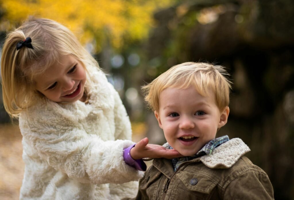 How Intentional Parenting Builds Resilient Kids smiling sister touching brother