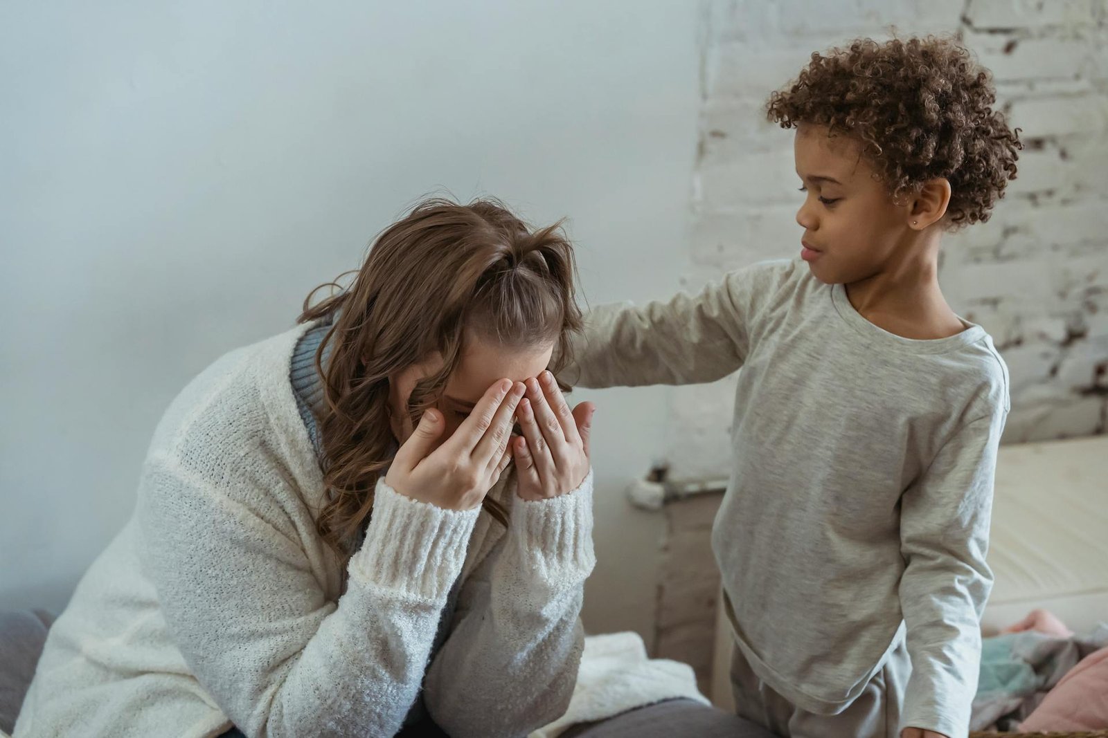 boy comforting his mother